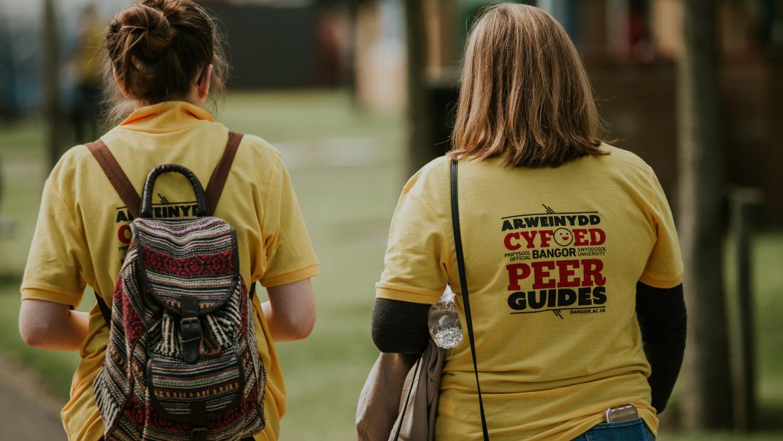 A couple of Peer Guides walking through Ffriddoedd Student Village during Welcome Week
