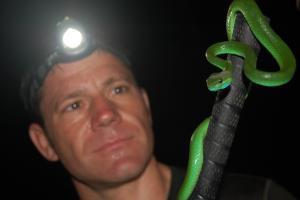 Steve Backshall holding a green snake