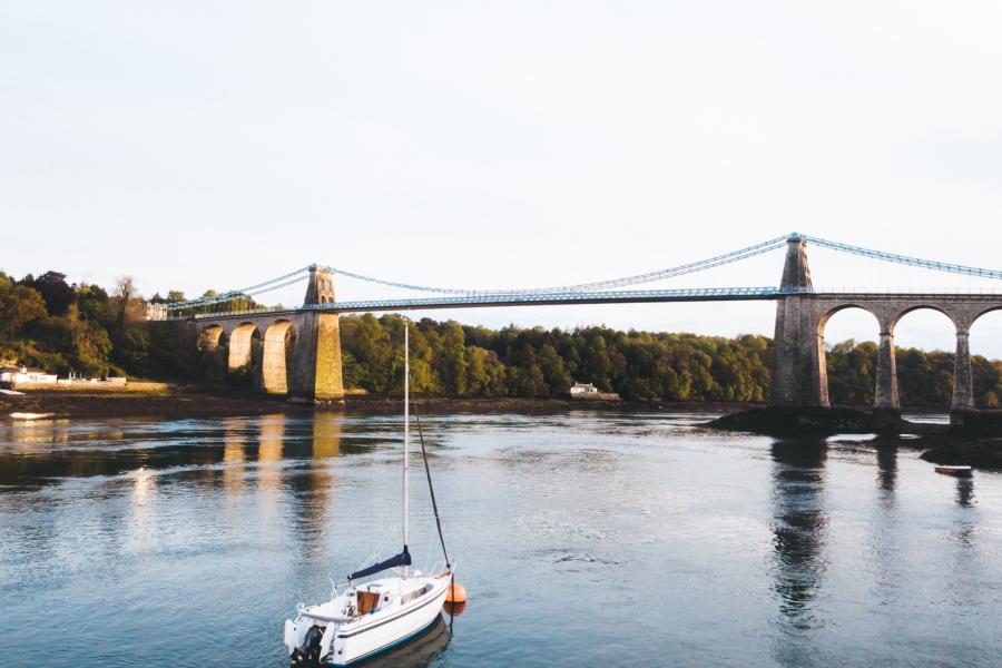 image of menai strait, bridge and a a boat sailing on the water
